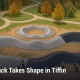 Fostoria News Pump track with winding curves and autumn trees in Tiffin park.